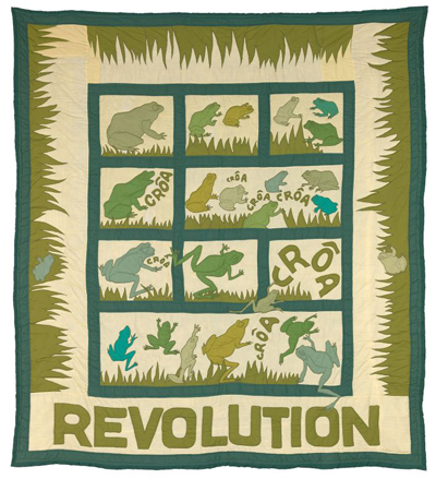 Frogs in blue and green jump around and cross over a grid pattern or hide in the grass along the edge of the textile piece. The word "REVOLUTION" appears along the bottom of the work.
